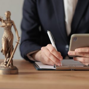 a female lawyer or a representative of the court sits in the office and checks the legal contract