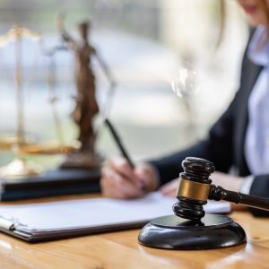 Business Asian woman in suit and Lawyer working on a documents at workplace office. Judge gavel