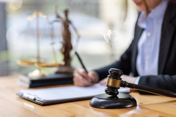 Business Asian woman in suit and Lawyer working on a documents at workplace office. Judge gavel