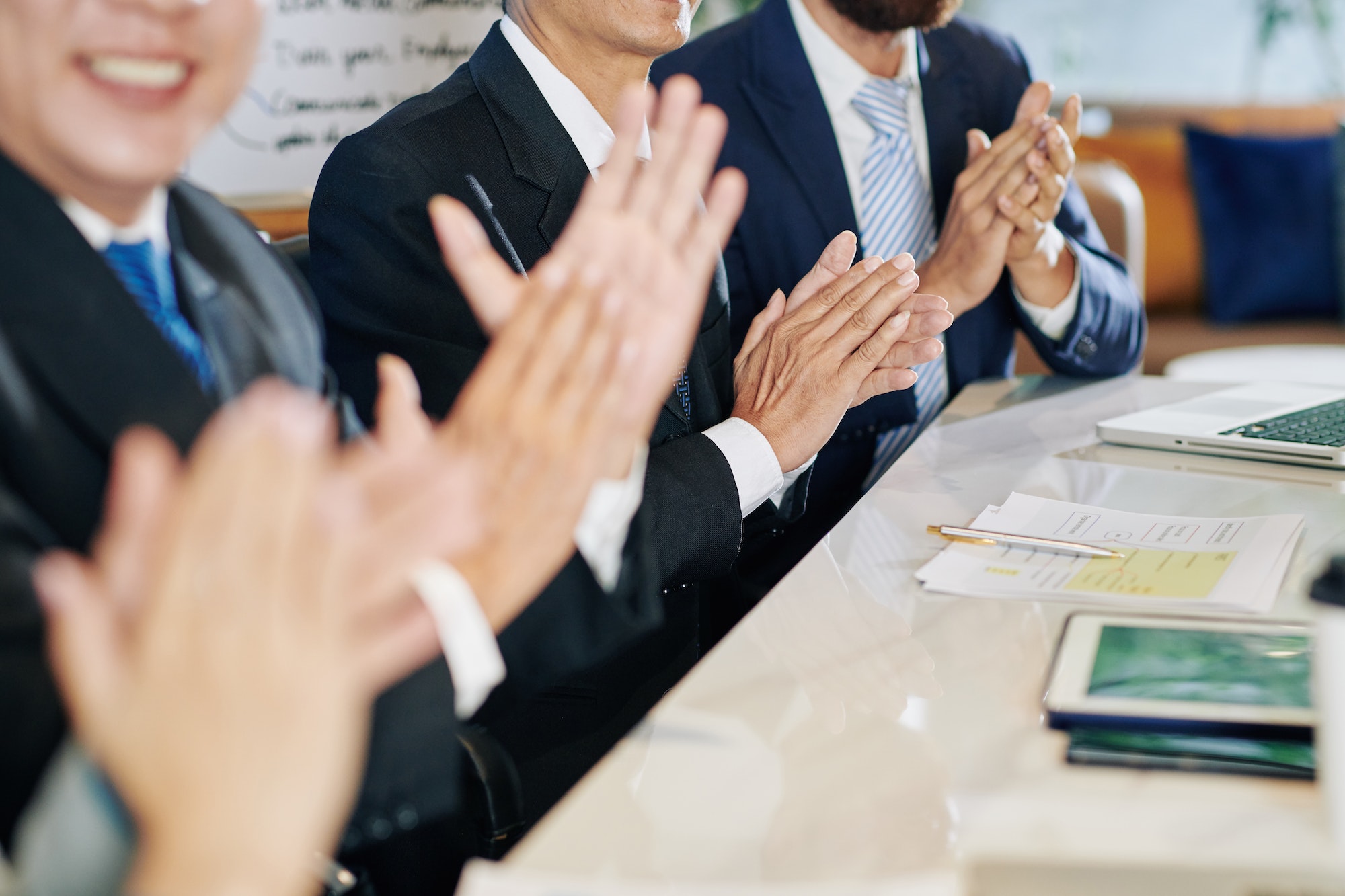 Clapping business people