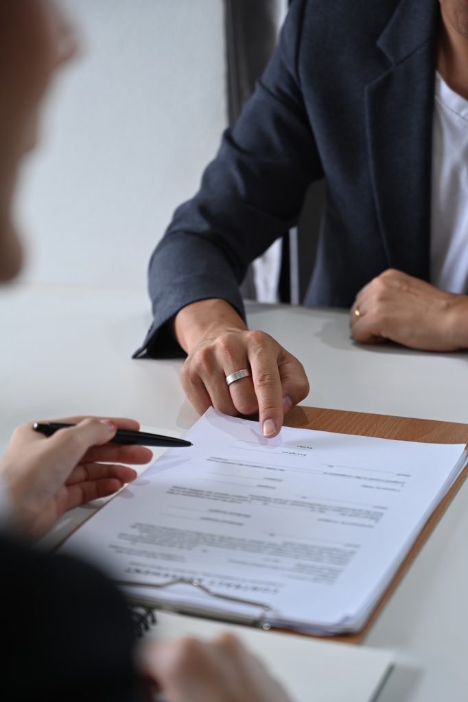 Cropped shot of male lawyer providing law consultation and legal advice to client.