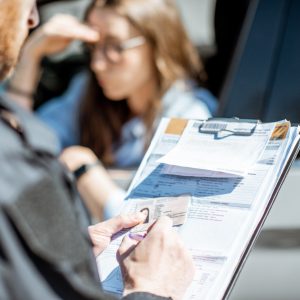 Policeman issuing a fine for a female driver